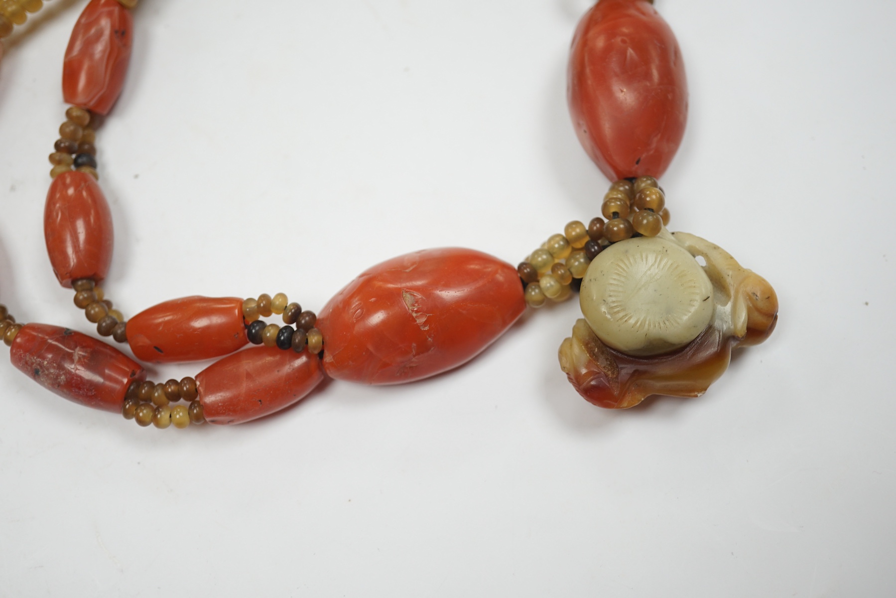 A mid 20th century Chinese chalcedony necklace, with carved pendant and sterling clasp, overall 54cm. Condition - poor to fair